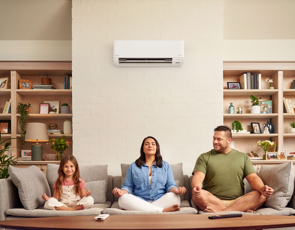 Happy Family Relaxing on Sofa — Air Conditioning Experts in Raymond Terrace, NSW