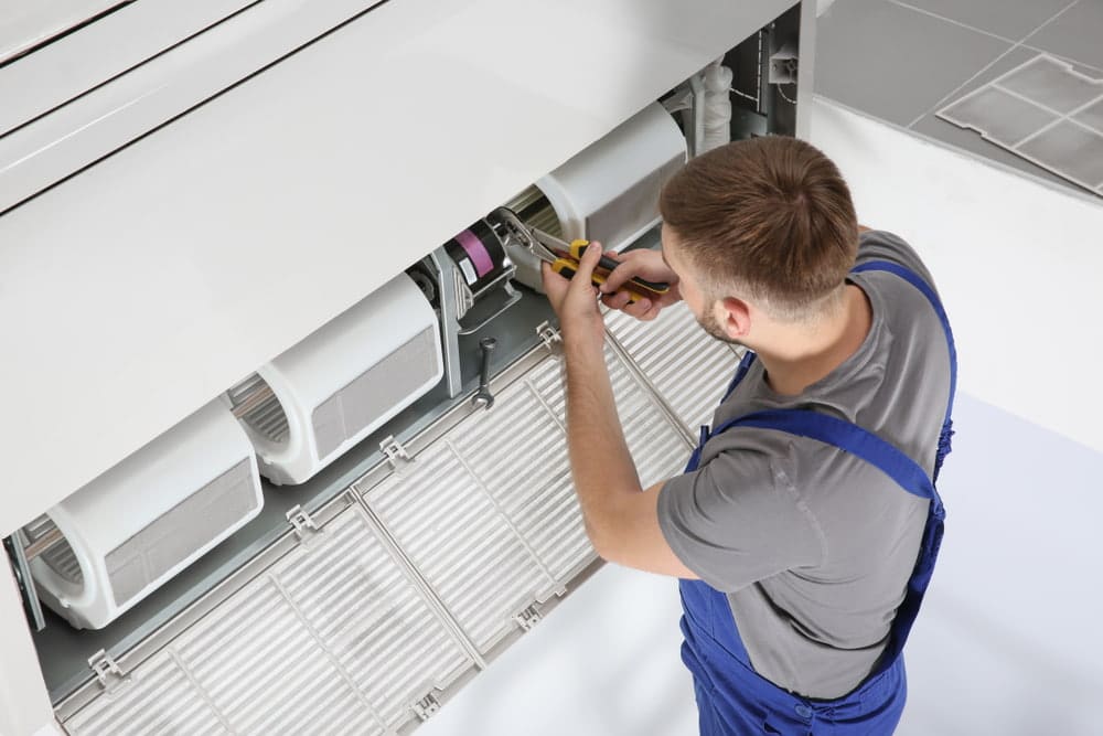 Aircon repair man — Air Conditioning Experts in Raymond Terrace, NSW